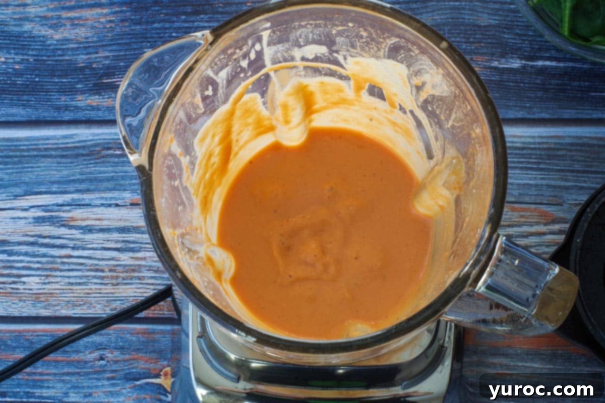Applesauce, egg yolks, lemon juice, maple syrup, and parmesan cheese added to blender and pureed.