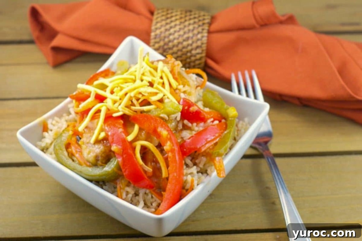 Plum glazed pork chops served in a white bowl with a brownish-orange napkin in the background.