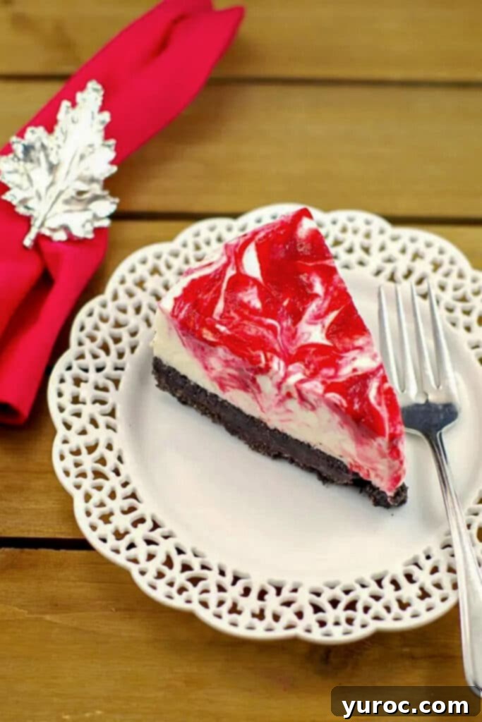 A delicious slice of strawberry rhubarb cheesecake on a pristine white plate, accompanied by a festive red napkin and a Canadian flag napkin ring.