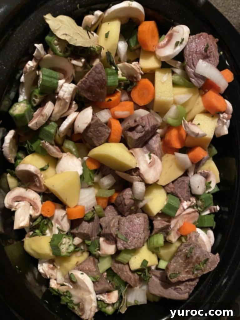 meat, veggies an herbs in a slow cooker