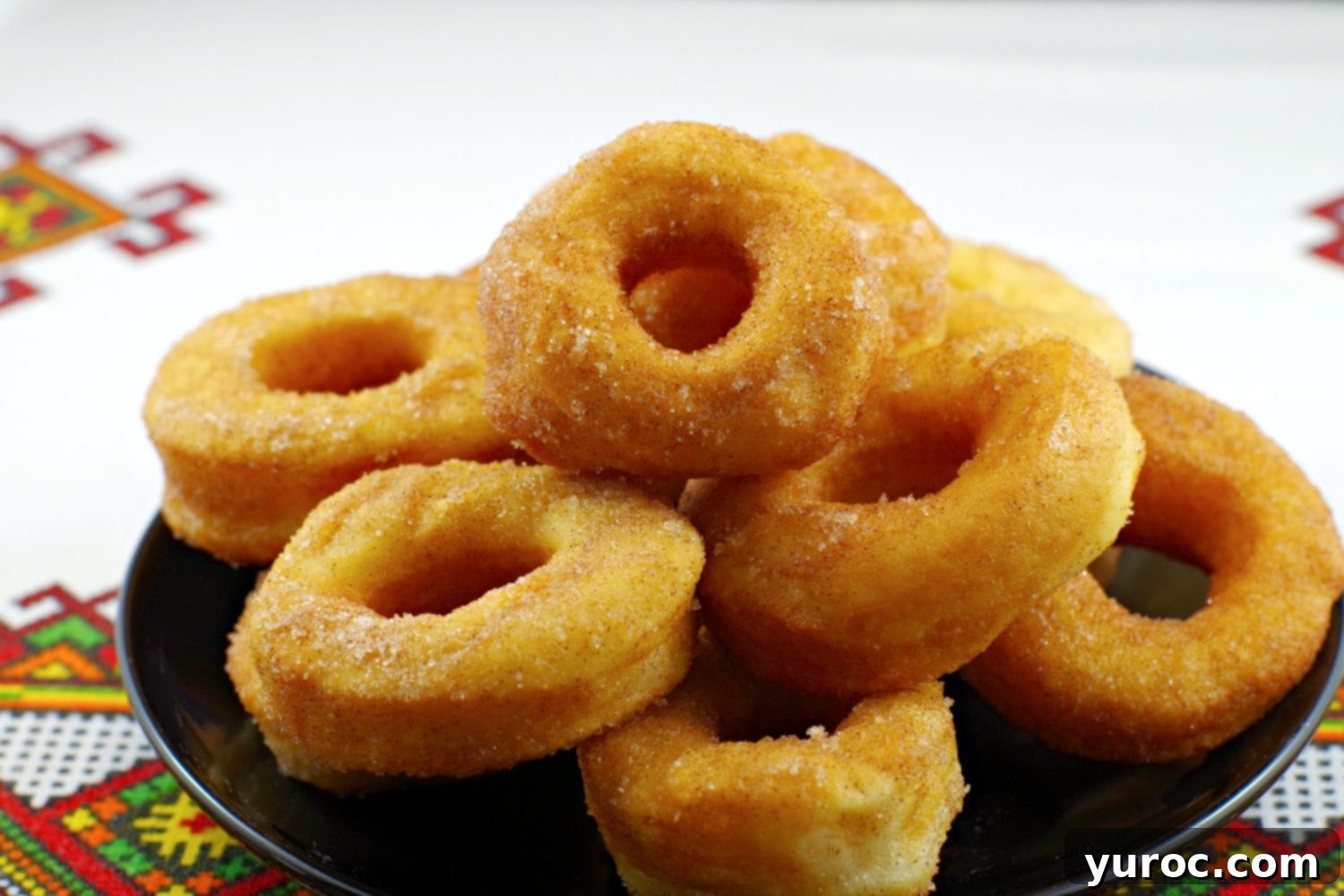Plate of homemade Pampushky, traditional Ukrainian donuts, beautifully arranged and ready to serve.