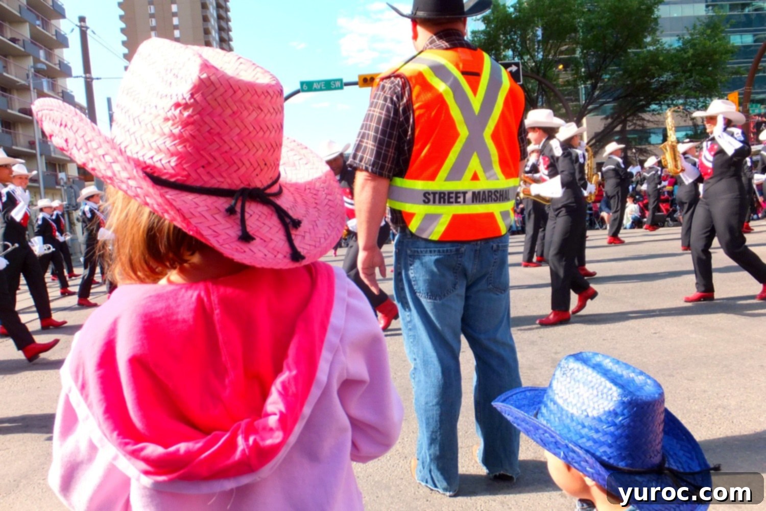 Excited crowd gathered for the Stampede Parade, enjoying the festive atmosphere with homemade Ukrainian doughnuts.