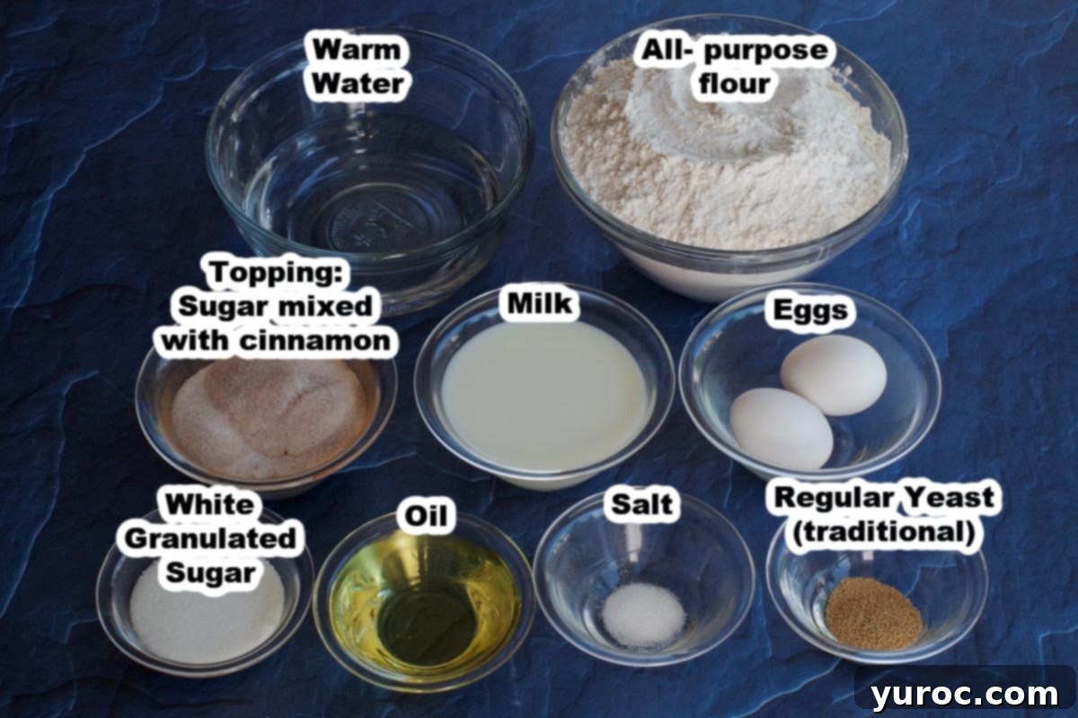 Various ingredients for Pampushky laid out in glass bowls on a blue surface, clearly labelled.