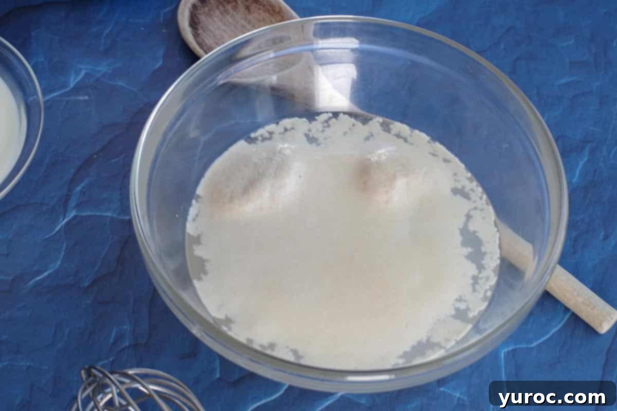 Yeast mixture actively bubbling after 10 minutes, indicating successful activation.