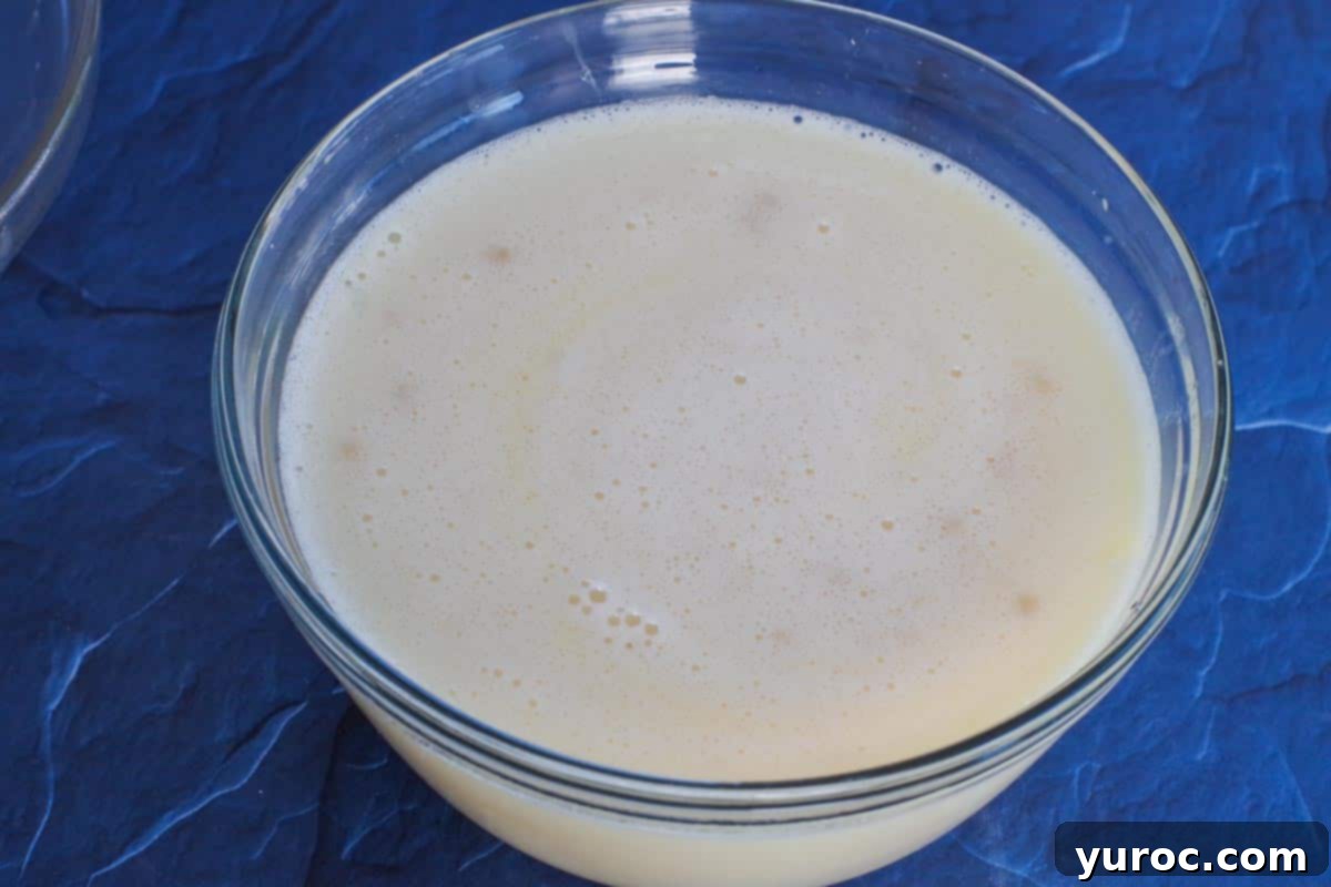 Yeast mixture being incorporated into the egg and milk mixture.