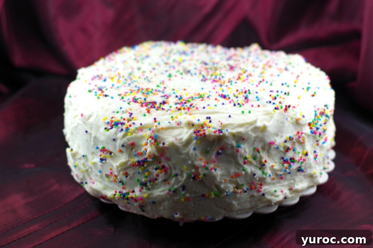 Decadent Red Velvet Ice Cream Cake 3 Two slices of Red Velvet Ice Cream Cake with white chocolate cream cheese frosting on a white plate