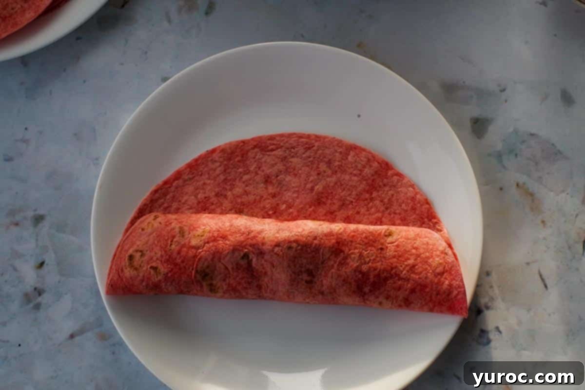 Tortilla folded to the centre from the bottom.