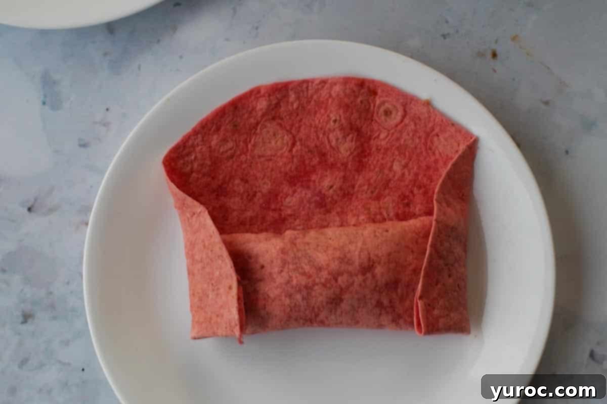 Each end folded towards the center.