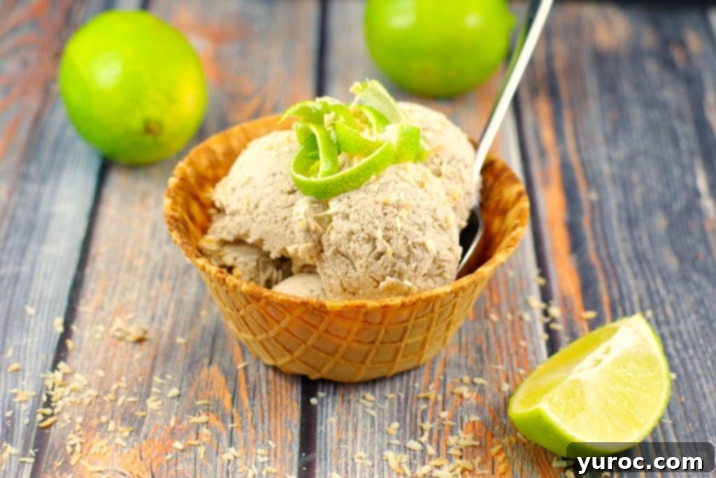 Creamy Banana Coconut Nice Cream topped with toasted coconut and lime zest, perfect for a healthy vegan dessert.