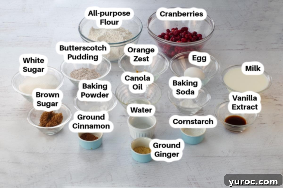 Holiday Spiced Gingerbread Pancakes with Sweet-Tart Cranberry Compote 4 A collection of ingredients for Gingerbread Christmas Pancakes, including flour, butterscotch pudding mix, spices, egg, milk, oil, and vanilla, neatly arranged in glass bowls.