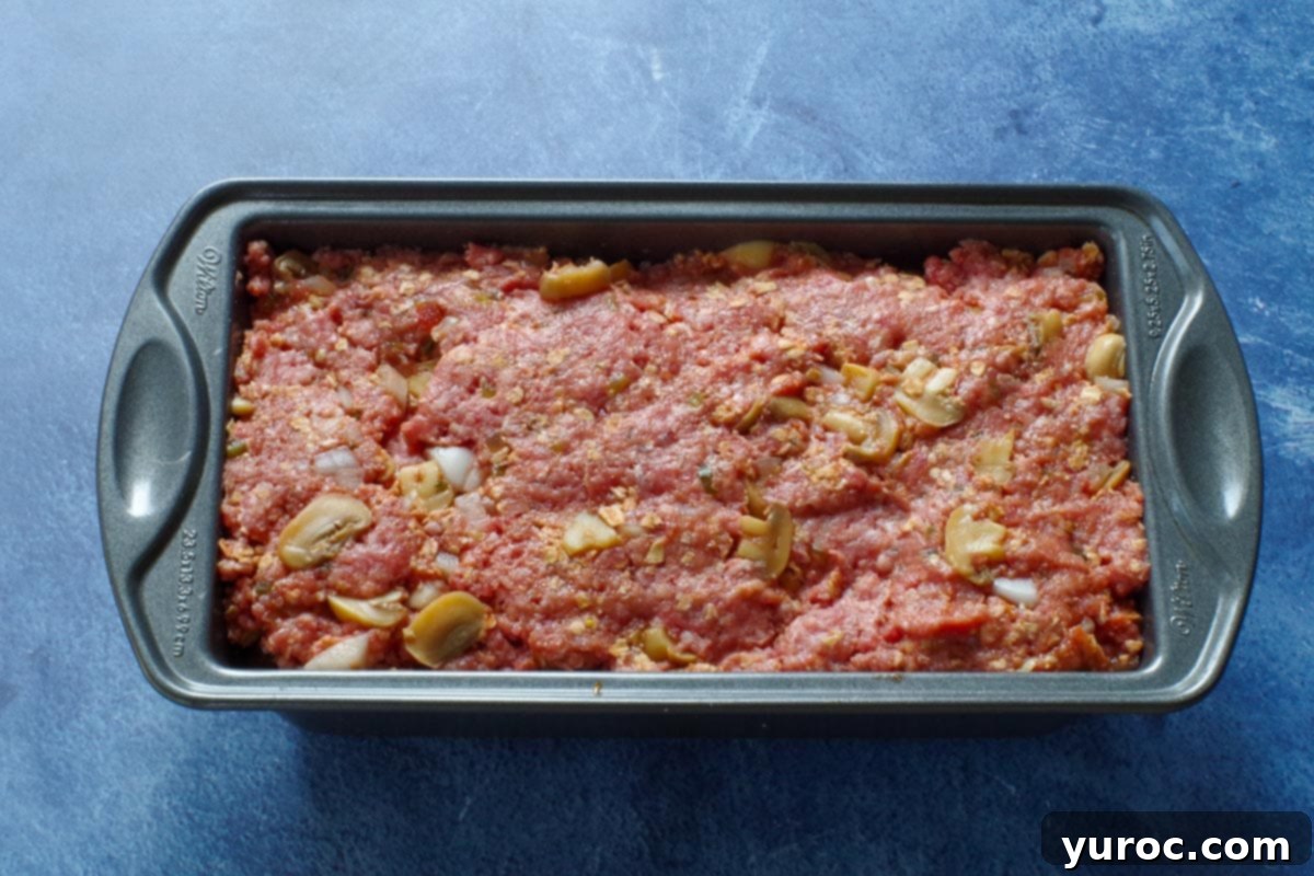 meatloaf mixture pressed into a loaf pan