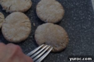 fork pressing into pita bread to make pie like imprint