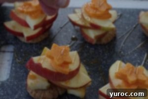 apple pie bites being garnished with additional cinnamon sugar