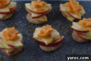 apple pie bites on grey cutting board, ready to serve