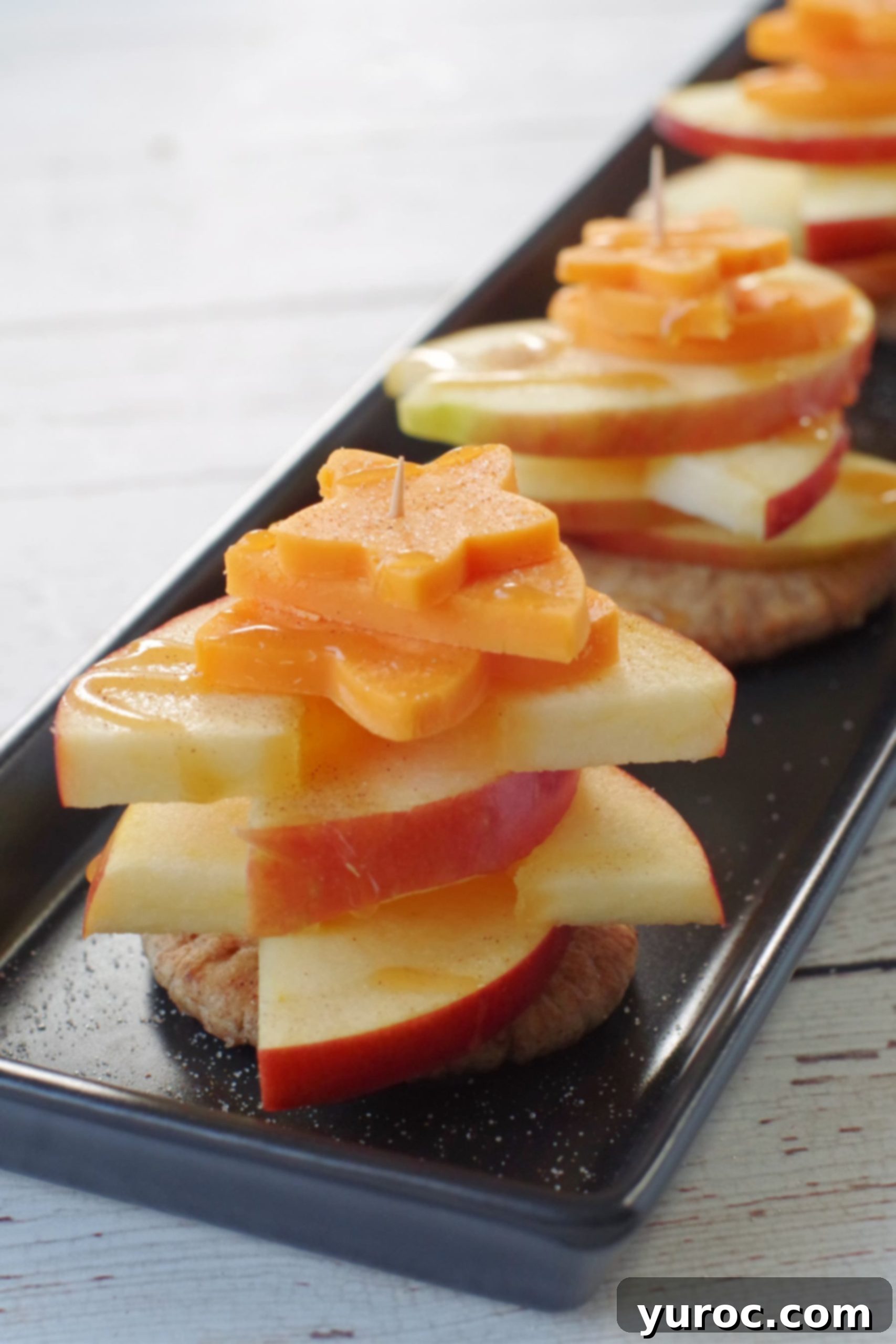 caramel apple pie bites on a narrow black tray