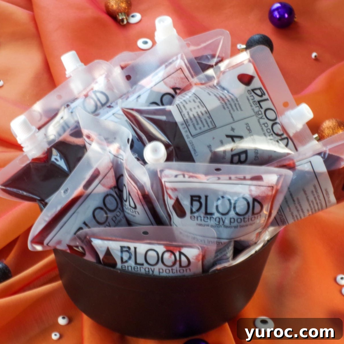 Spooky Swamp Trifle with Wriggling Worms 8 Halloween blood bag drinks displayed in a rustic black cauldron, perfect for a spooky party.
