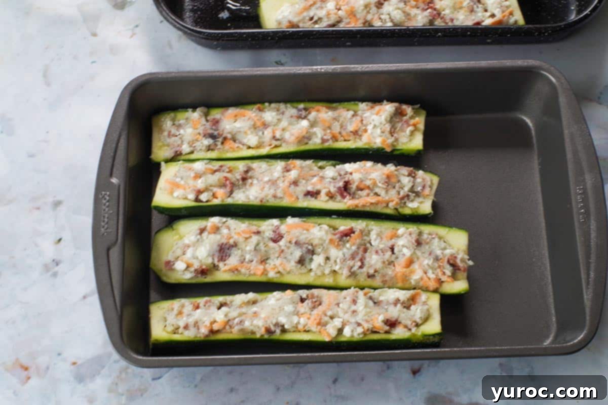 Pierogi filling stuffed into zucchini and flattened with a spoon.