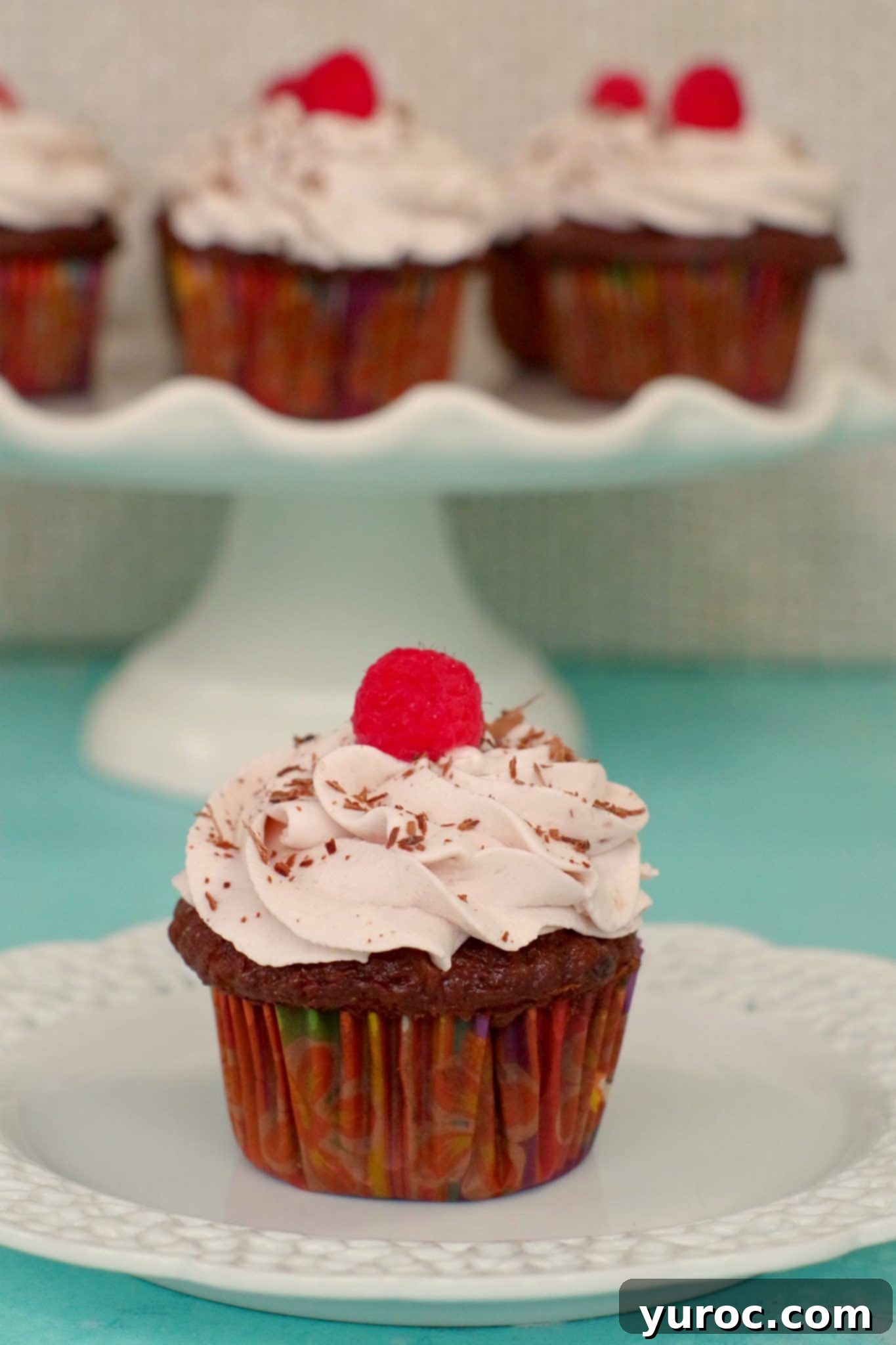 Cake Mix Tiramisu Cupcakes 7 tiramisu cupcake on a white plate, with a white stand of cupcakes in the background