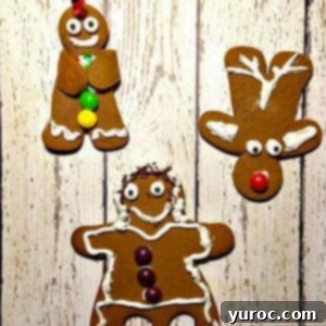 3 gingerbread cookies (a reindeer, dancing gingerbread girl and a gingerbread man) on a white faux wooden surface