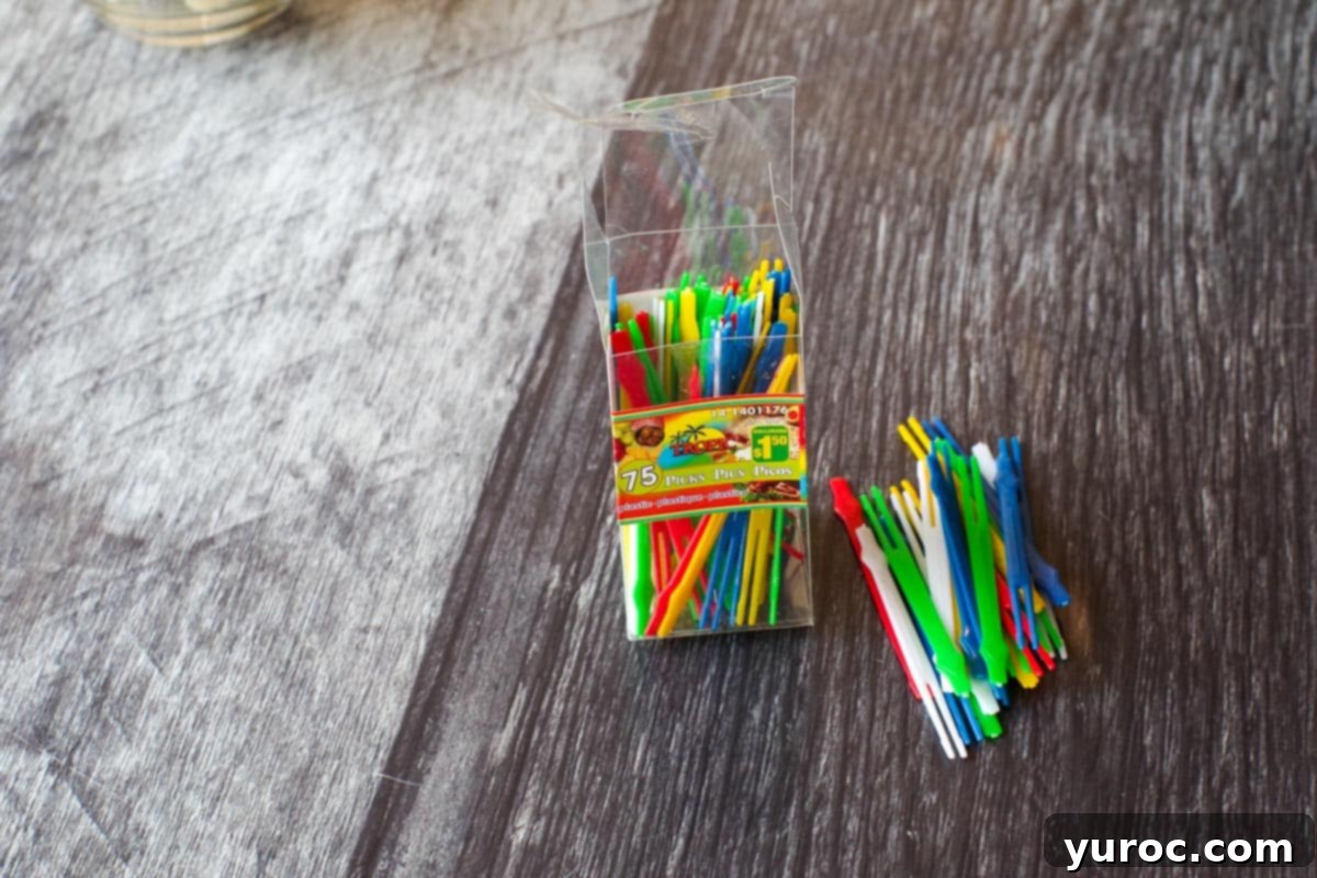 Plastic skewer sticks (some in a box) and some beside the box
