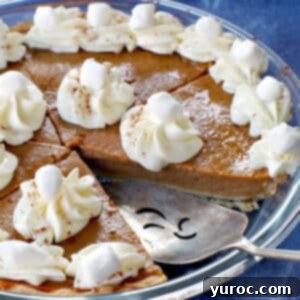Toasted Marshmallow Sweet Potato Delight 17 Sweet potato pie with marshmallow whipped cream in glass pie plate with piece missing and pie lifter in missing spot.