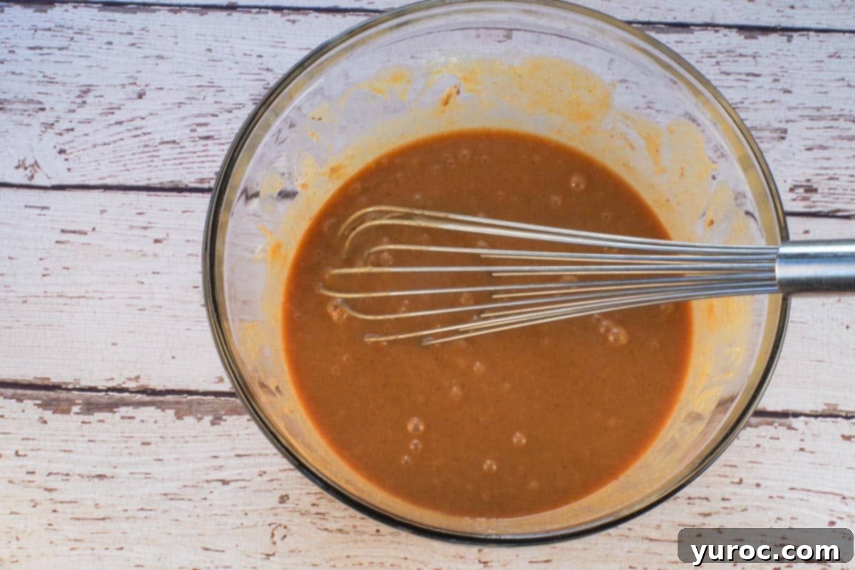 Toasted Marshmallow Sweet Potato Delight 6 Sweet potato pie filling ingredients whisked until combined in large glass bowl with large metal whisk.