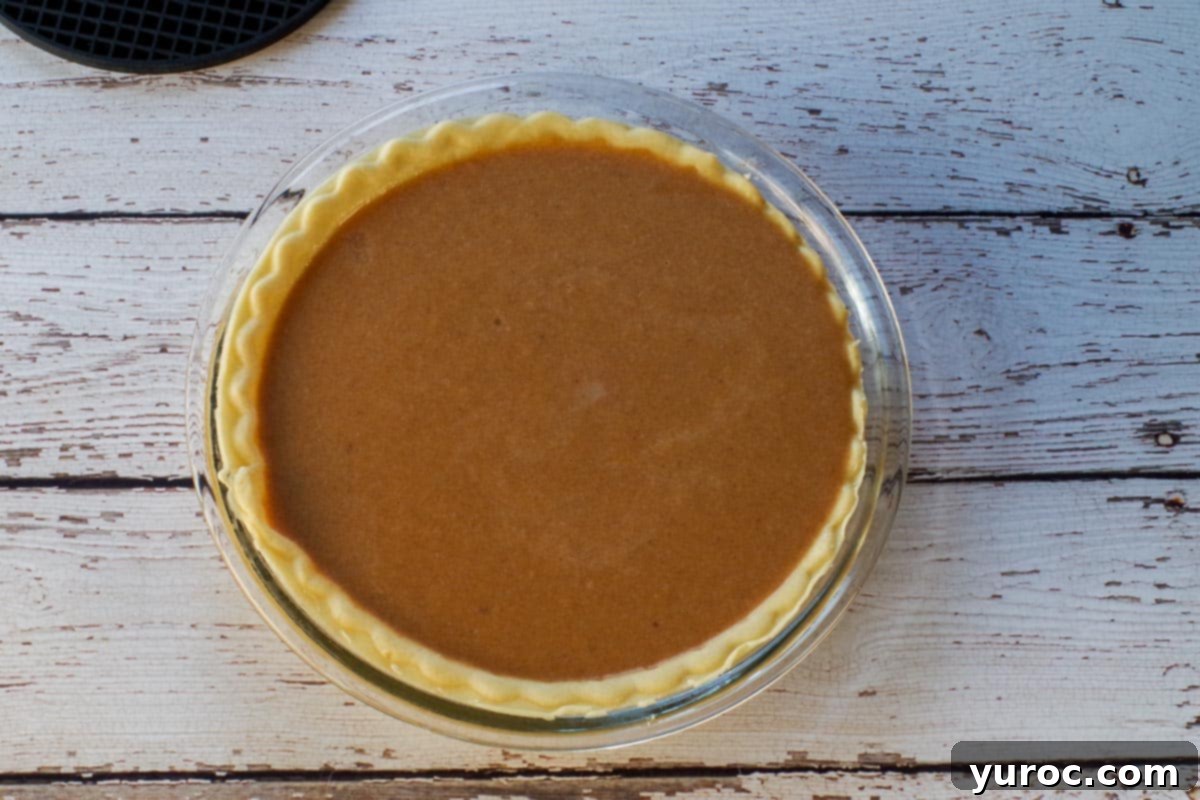 Toasted Marshmallow Sweet Potato Delight 7 Sweet Potato Pie filling poured into a deep dish pie crust.