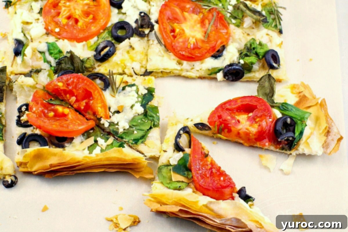 Greek Phyllo Vegetable Tart 2 Crispy Greek Phyllo Pizza sliced into triangles with fresh tomatoes, feta, and basil
