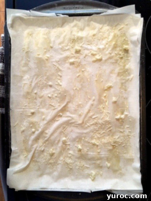 Greek Phyllo Vegetable Tart 3 Phyllo pizza making step 1: Layering phyllo with butter and cheese