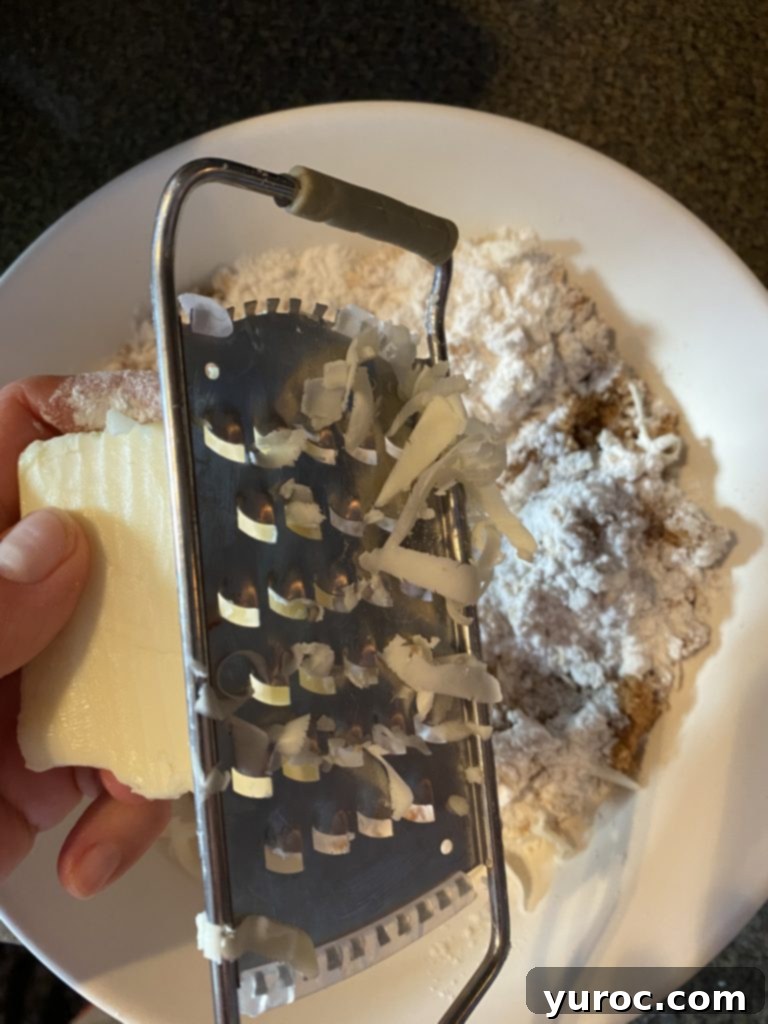 butter being grated into oat and flour mixture