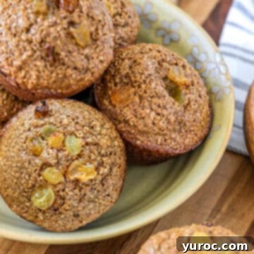 15 Deliciously Healthy Bran Muffin Recipes 16 A cozy bowl filled with freshly baked raisin bran muffins, their tops perfectly golden and speckled with sweet raisins, evoking a sense of warmth, comfort, and homemade goodness.