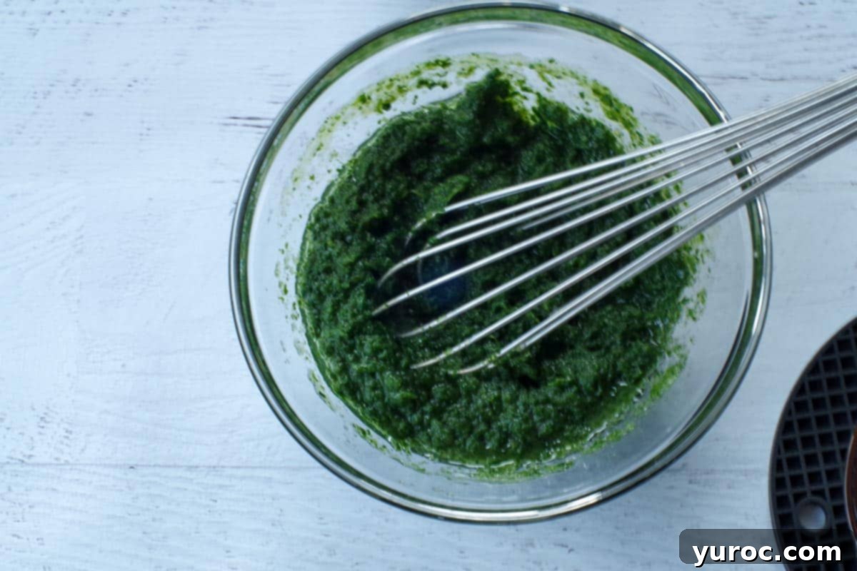 Sneaky Spinach Applesauce Brownies 6 wet ingredients in a glass bowl with a metal whisk