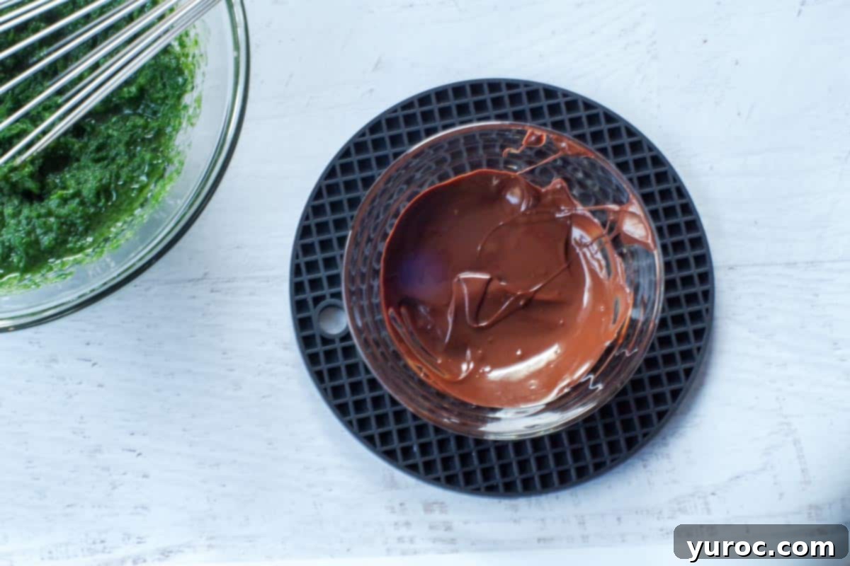 Sneaky Spinach Applesauce Brownies 8 chocolate melted in small glass bowl, sitting on black trivet