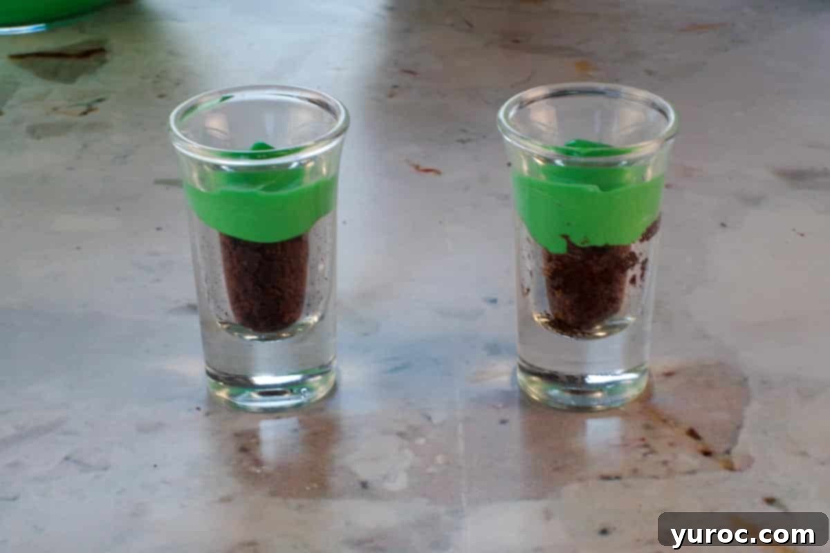St. Patrick's Day Shamrock Irish Cream Shots 13 2 shot glasses with green pudding added over brownie.