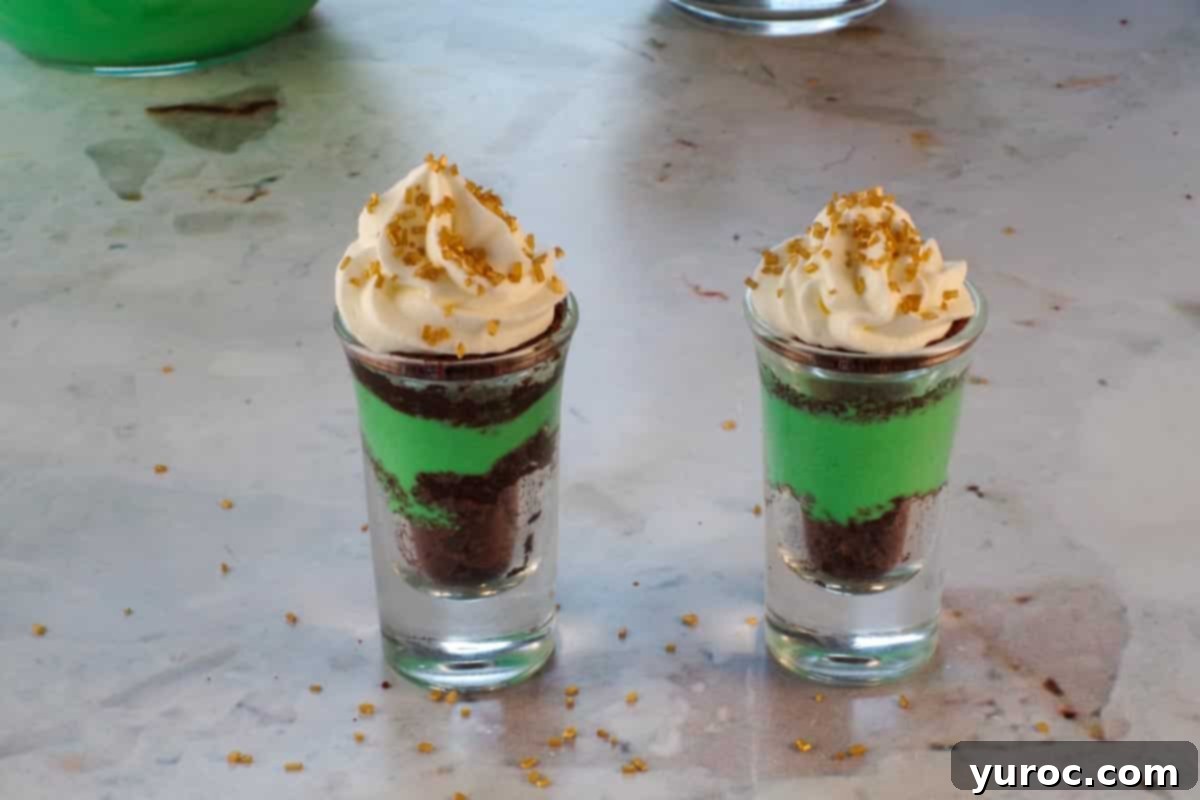 St. Patrick's Day Shamrock Irish Cream Shots 16 Scattered gold sprinkles over the whipped cream and pudding/ brownie mixture in 2 shot glasses.