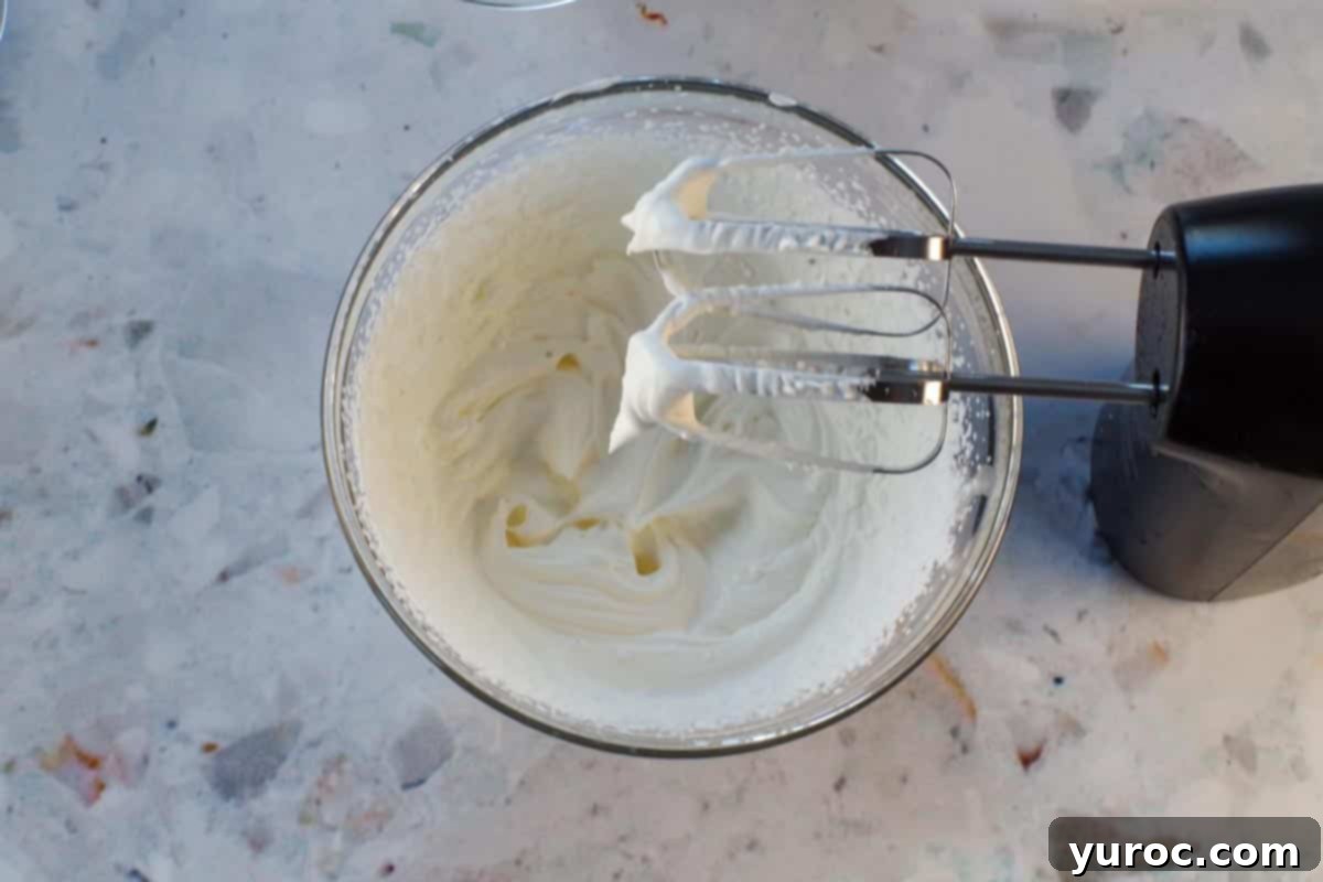 St. Patrick's Day Shamrock Irish Cream Shots 7 Whipped cream whipped to soft peaks in glass bowl with beaters over the bowl.