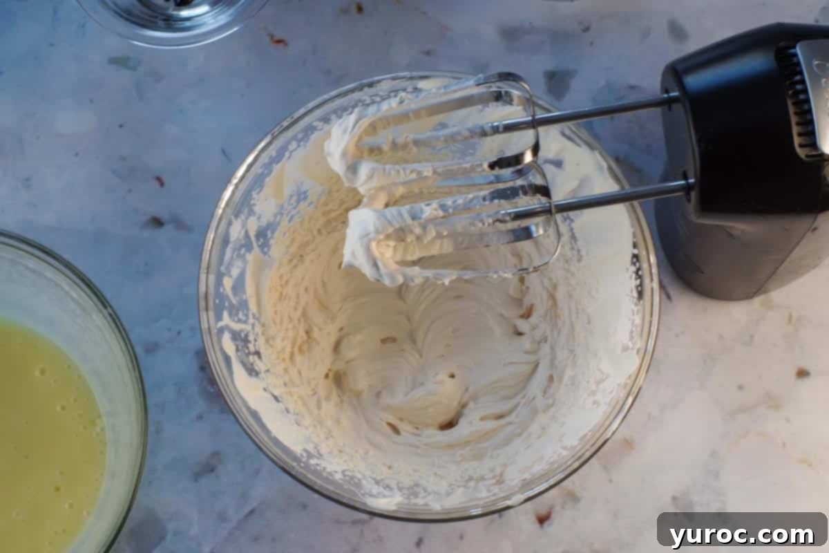 St. Patrick's Day Shamrock Irish Cream Shots 9 Whipped cream with Irish Cream whipped to stiff peaks in glass bowls with beaters over bowl.