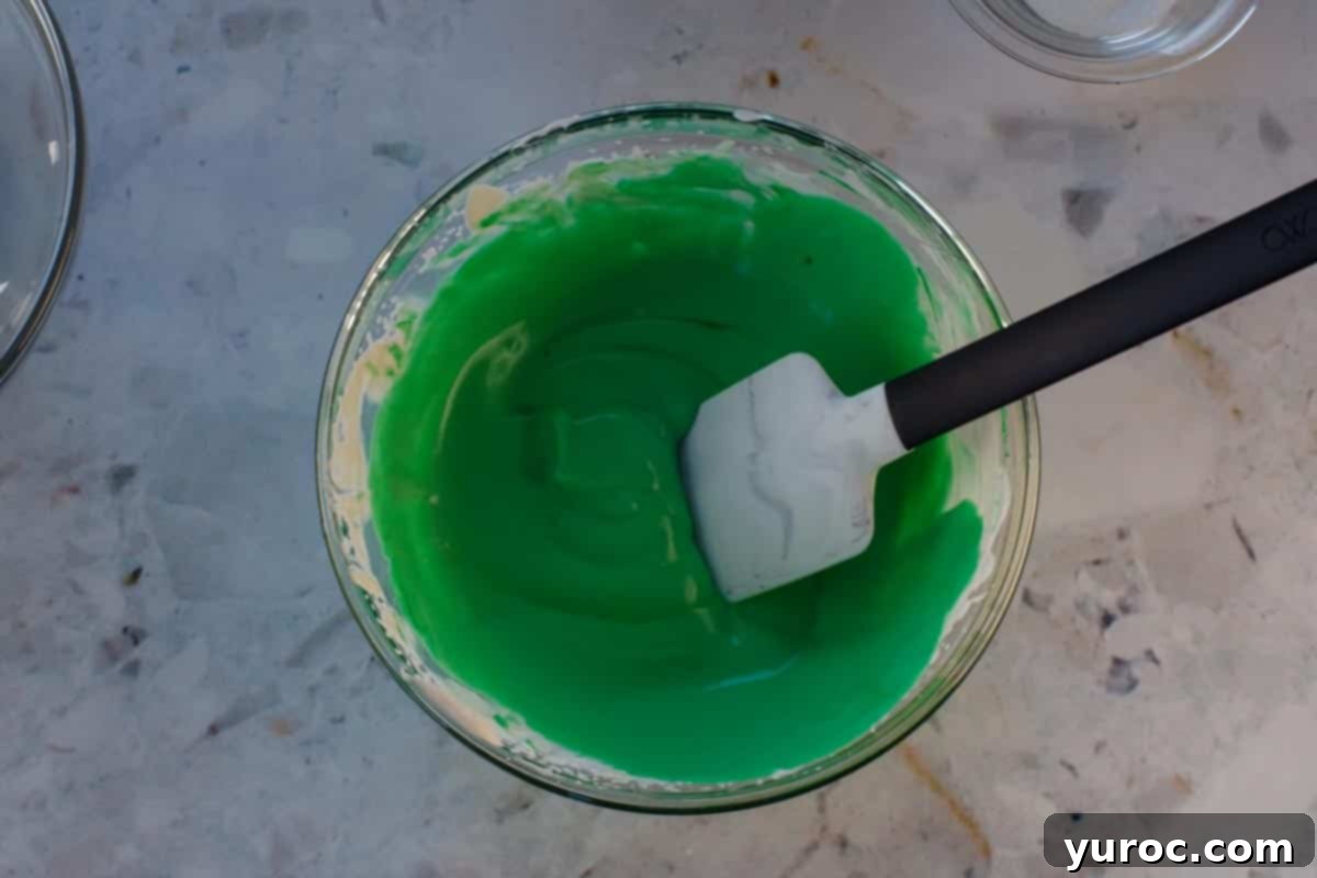 St. Patrick's Day Shamrock Irish Cream Shots 10 Whipped cream pudding and food coloring mixed together in glass bowl with marbled spatula.