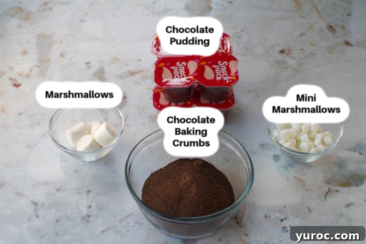 Glass bowls containing chocolate pudding, chocolate baking crumbs, and various marshmallows, ready for Easter Dirt Cup assembly.