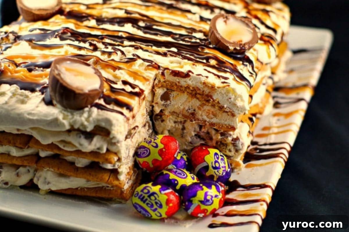 Easy Easter Creme Egg Icebox Cake on a white platter with a slice removed, revealing layers and mini Easter Creme Eggs.