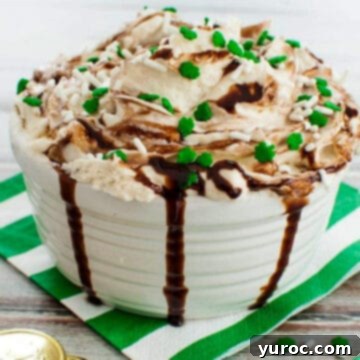 A delightful Baileys Irish Cream Dip served in a pristine white dish, elegantly placed on a white and green striped napkin, ready to be enjoyed as a St. Patrick's Day treat.