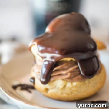 Delicate Irish Cream Cream Puffs beautifully arranged on a white plate, showcasing their inviting and elegant presentation, ideal for a St. Patrick's Day spread.