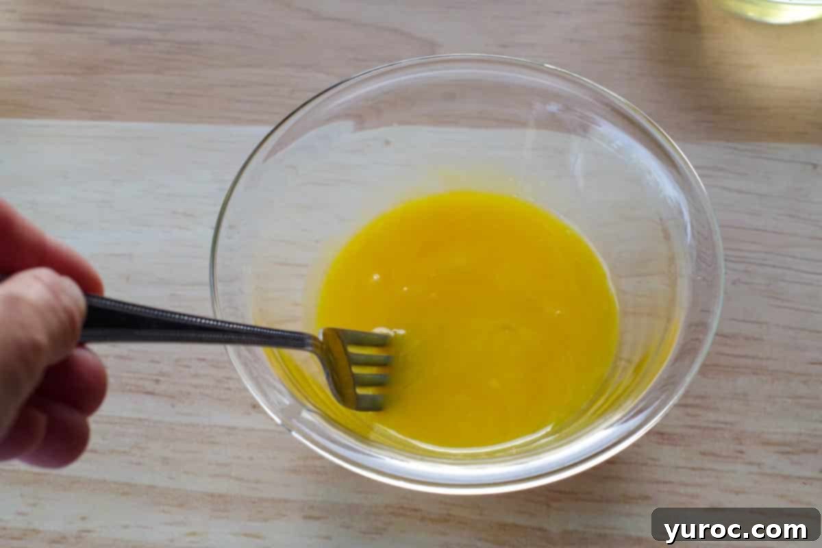 Decadent Belgian Chocolate Waffles 5 egg yolks being beaten with a fork