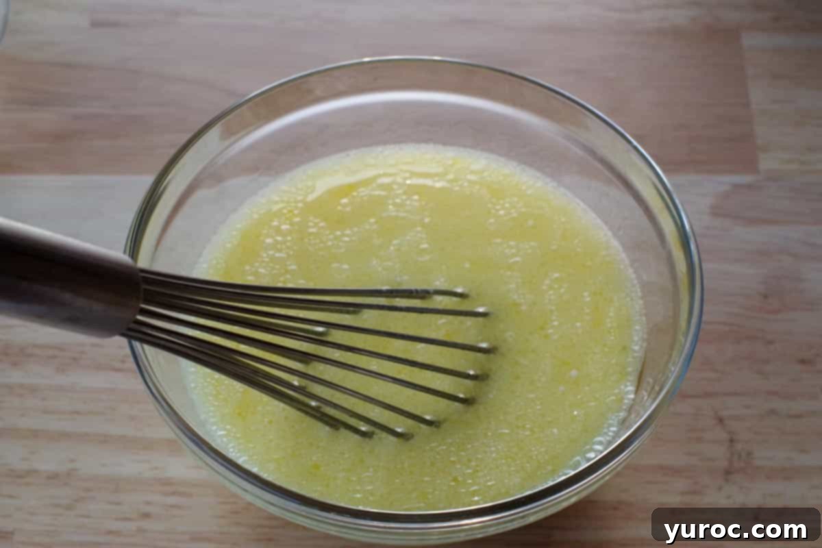 Decadent Belgian Chocolate Waffles 6 milk, egg yolks and vegetable oil in a glass bowl, being whisked together