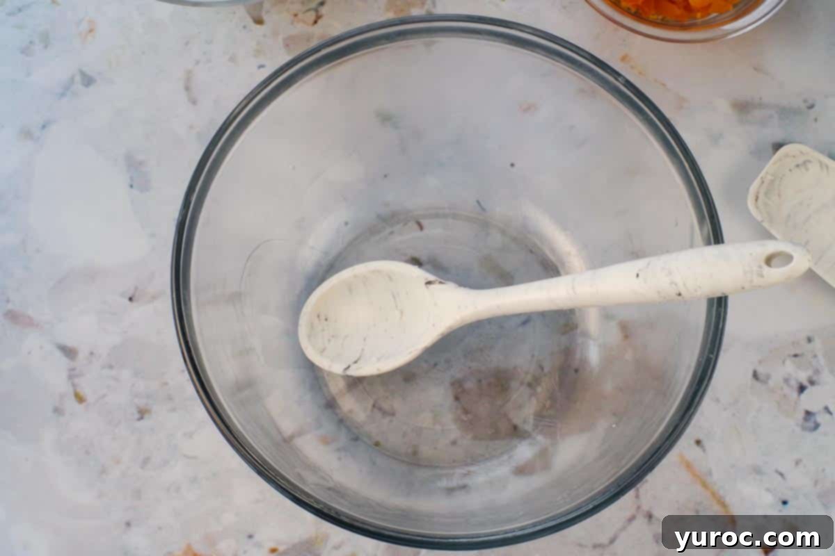 Large greased glass bowl and greased spoon.