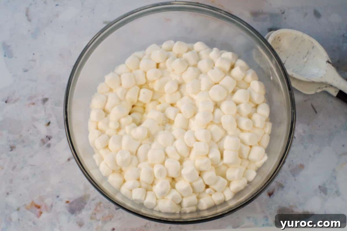 Marshmallows partially cooked in large glass bowl.