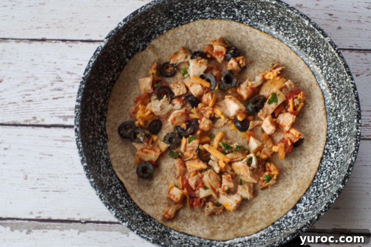 Quick Rotisserie Chicken Quesadillas 6 Filling added to tortilla.