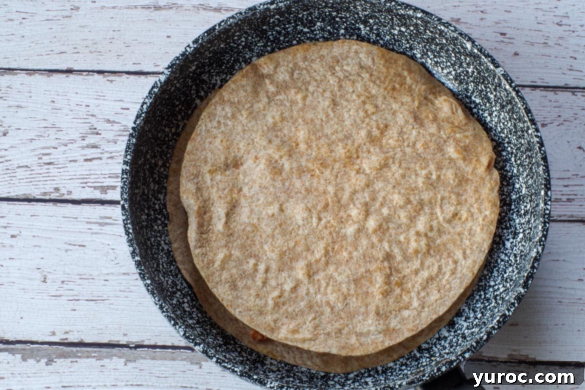 Quick Rotisserie Chicken Quesadillas 7 Browned tortilla taken from the other pan and put on top.