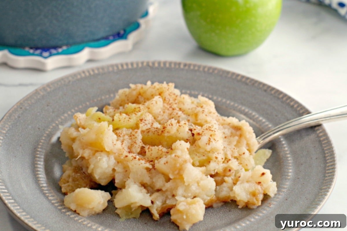 Golden Turnip Apple Bake 3 turnip and apple casserole on a grey plate with fork and apple and blue casserole dish in the background