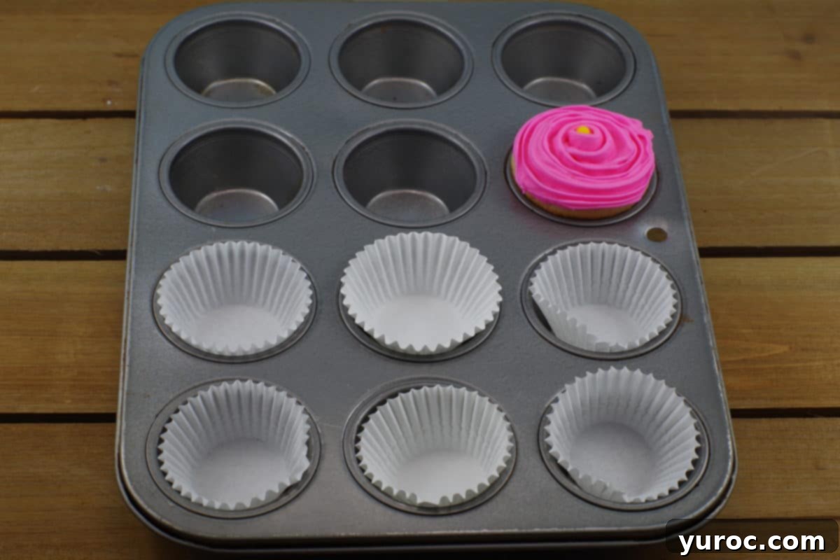 Sweet Seedlings 10 Preparing to ice a flower cupcake with pink frosting.